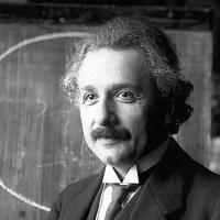 Albert Einstein in front of a blackboard.